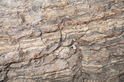 Rough brown stone wall, natural rock