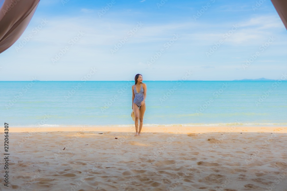 Portrait beautiful young asian woman happy smile relax on the tropical beach sea ocean for leisure travel Portrait beautiful young asian woman happy smile relax on the tropical beach sea ocean for leisure travel