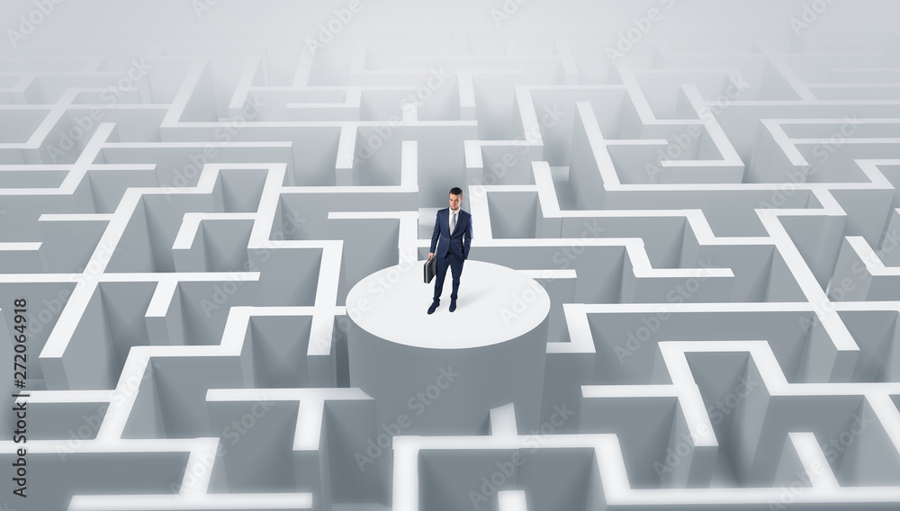 Businessman standing on the top a maze and looking through
Businessman standing on the top a maze and looking through