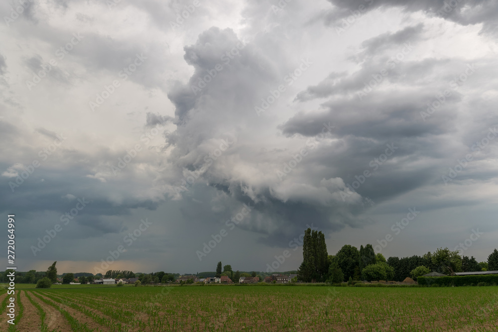 Rotating storm clouds over the green landscape of Flanders, Belgium (western Europe) Rotating storm clouds over the green landscape of Flanders, Belgium (western Europe)