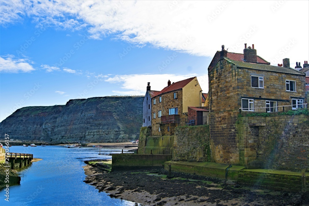 Sunstreak across Staithes Harbour and Cowbar Nab, near Scarborough, North Yorkshire.
