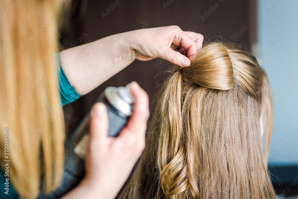 A WOMAN GETTING A HAIR DO BY A PROFFESIONAL HAIRDRESSER A WOMAN GETTING A HAIR DO BY A PROFFESIONAL HAIRDRESSER