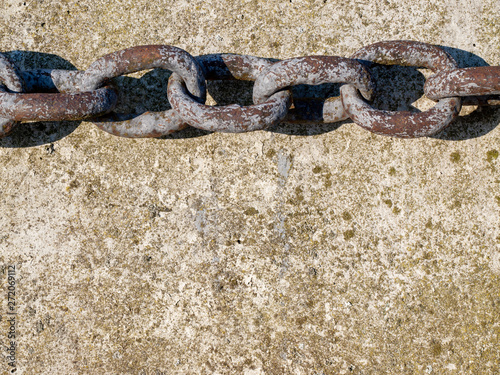 Iron chain on concrete pier.