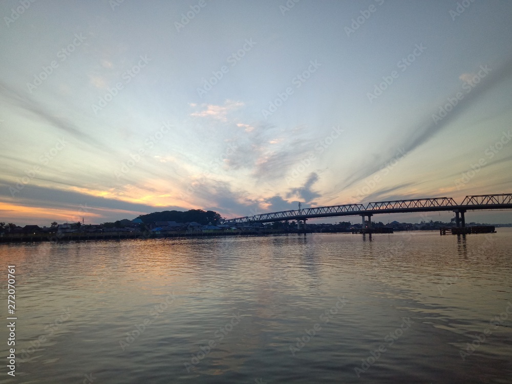 Fototapeta premium the sky when the sun will rise in the river with the bridge