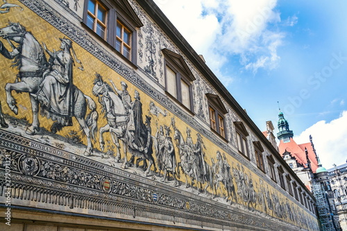 Public street view of the largest porcelain artwork in the world Furstenzug - Procession of Princess in Dresden, Germany, mural of a mounted procession of Saxony rulers