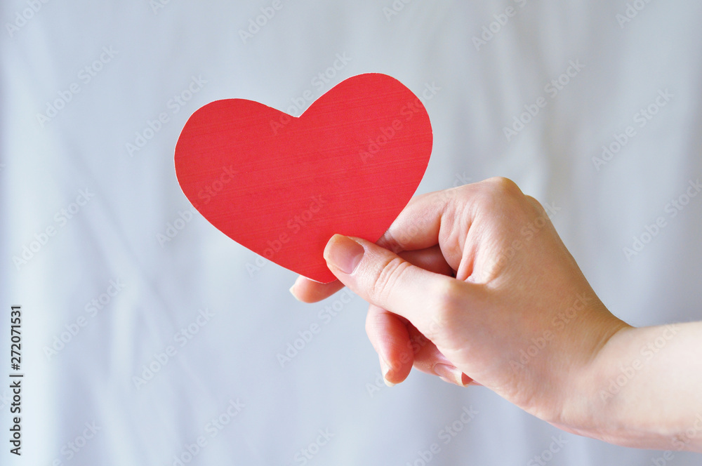 Small items in hand: scissors, paper heart, ball. Small items in hand: scissors, paper heart, ball.