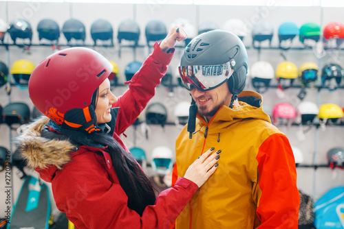 Couple check the strength of the ski helmet