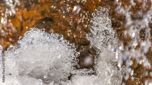 Panorama frame Close up of crystalline ice and brown rock covered with shiny frozen water