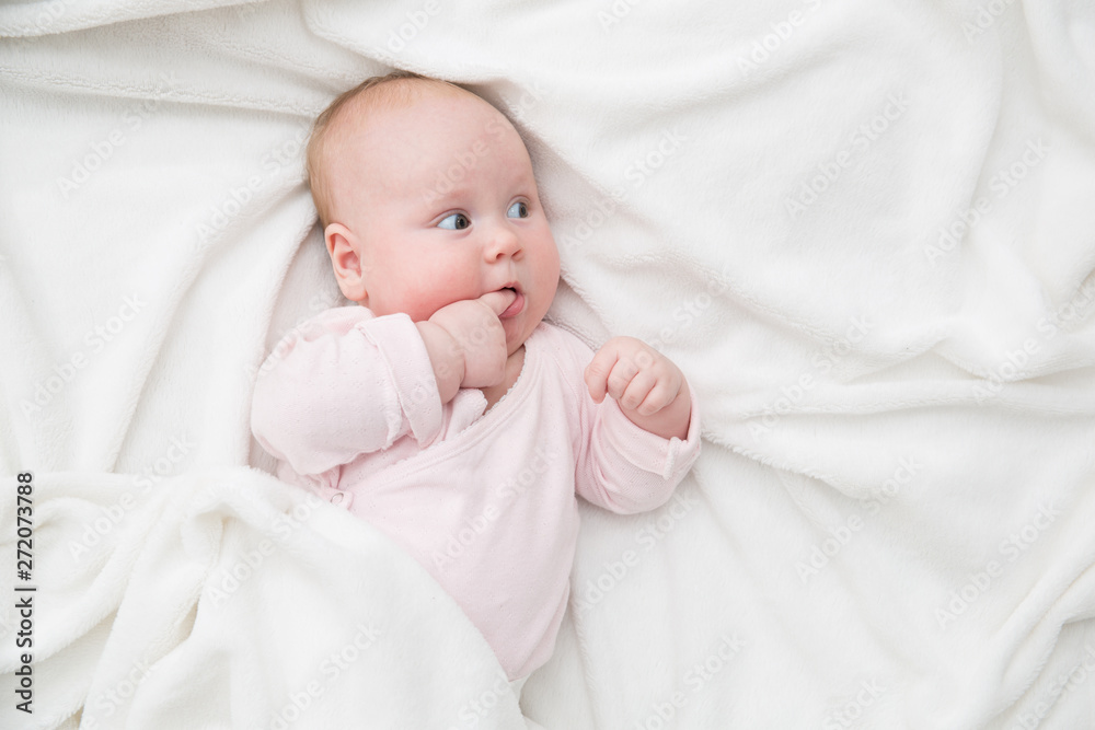 Baby Girl lie in bed, Newborn Child Covered By white Blanket, copy space Baby Girl lie in bed, Newborn Child Covered By white Blanket, copy space