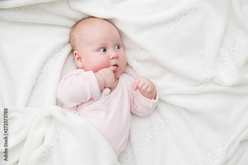 Baby Girl lie in bed, Newborn Child Covered By white Blanket, copy space