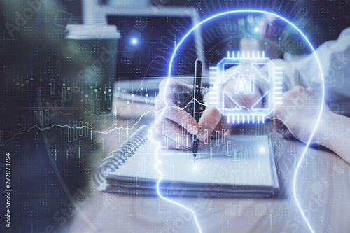 Multi exposure of writing hand on background with brain hologram. Concept of learning.