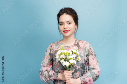  Elegant young woman focused on portrait over blue background