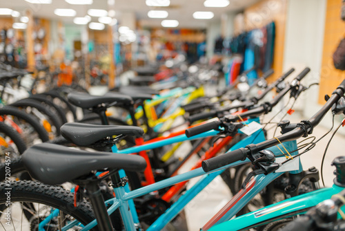 Rows of bicycles in sports shop, focus on seat