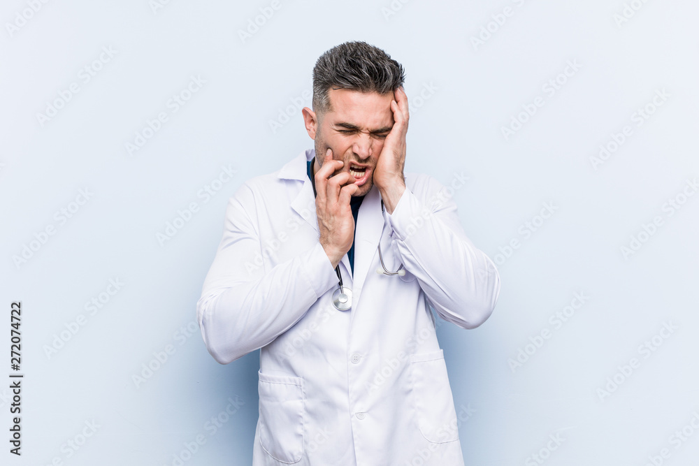 Young handsome doctor man whining and crying disconsolately. Young handsome doctor man whining and crying disconsolately.