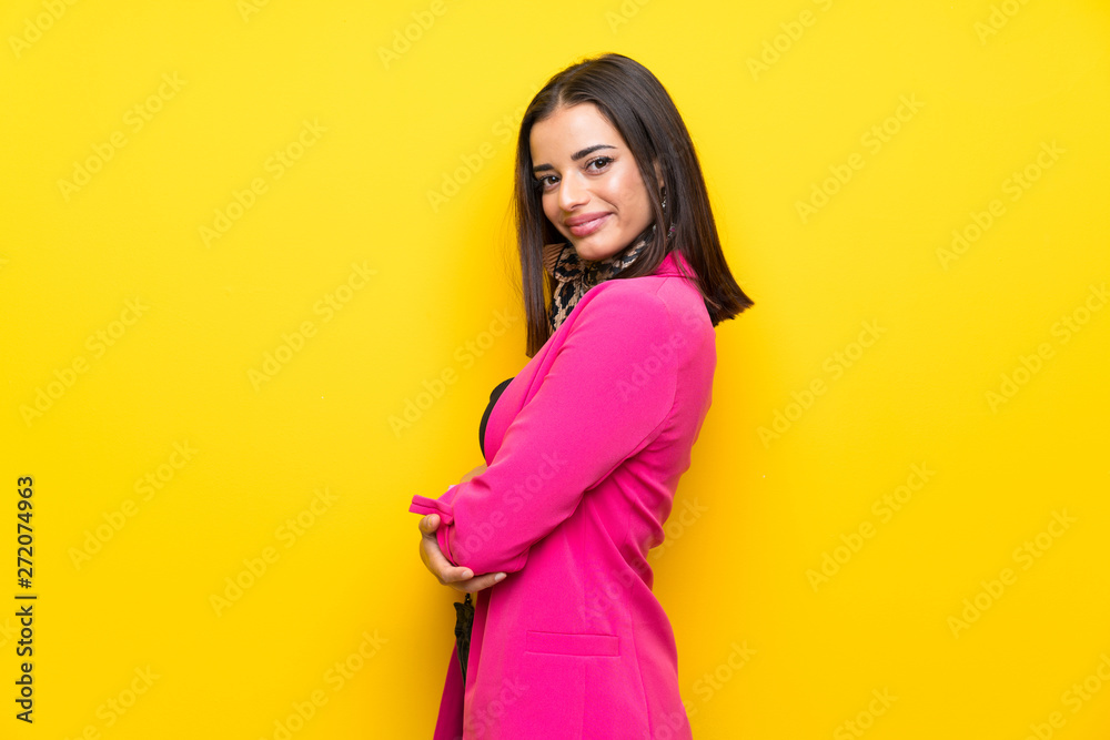 Young woman over isolated yellow background laughing Young woman over isolated yellow background laughing
