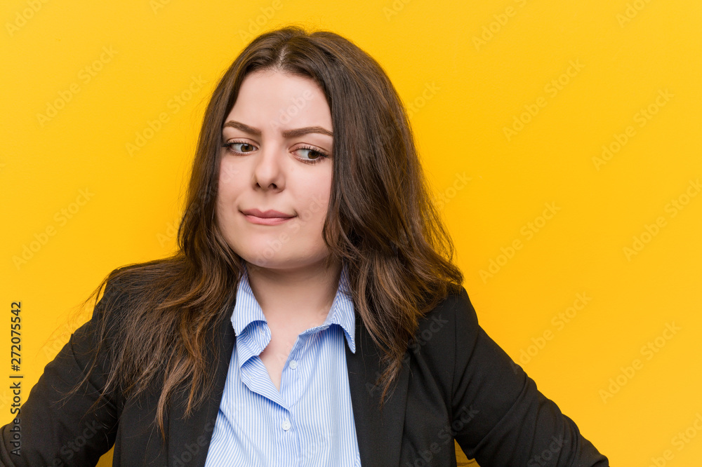 Young plus size caucasian business woman confused, feels doubtful and unsure. Young plus size caucasian business woman confused, feels doubtful and unsure.
