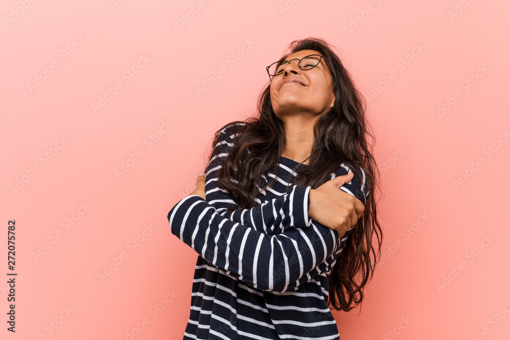 Young intellectual indian woman hugs himself, smiling carefree and happy. Young intellectual indian woman hugs himself, smiling carefree and happy.