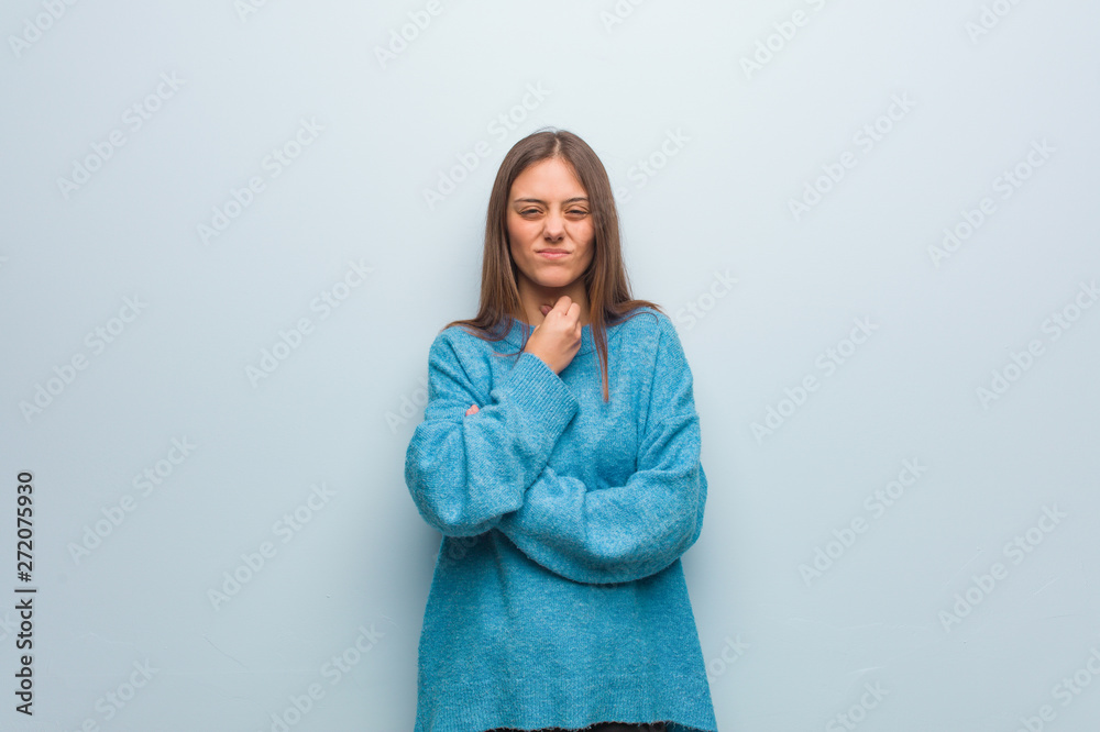 Young pretty woman wearing a blue sweater coughing, sick due a virus or infection Young pretty woman wearing a blue sweater coughing, sick due a virus or infection