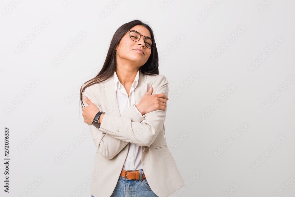 Young business arab woman isolated against a white background hugs, smiling carefree and happy. Young business arab woman isolated against a white background hugs, smiling carefree and happy.