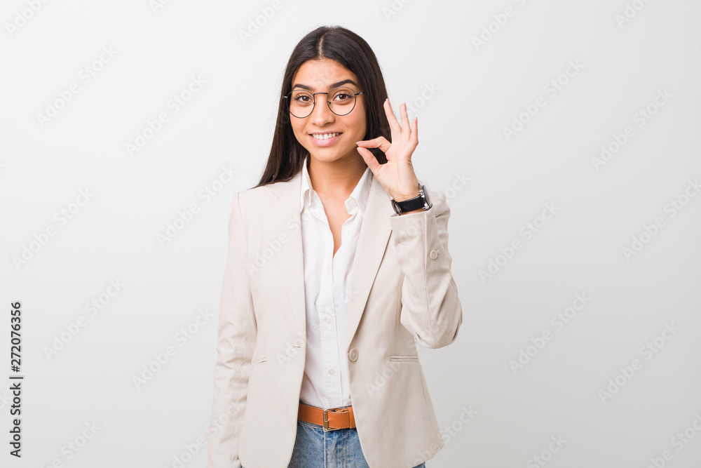 Young business arab woman isolated against a white background cheerful and confident showing ok gesture. Young business arab woman isolated against a white background cheerful and confident showing ok gesture.