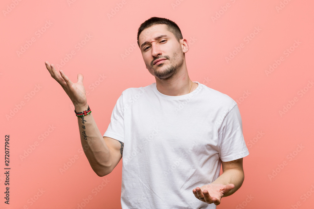 Young casual man doubting between two options. Young casual man doubting between two options.