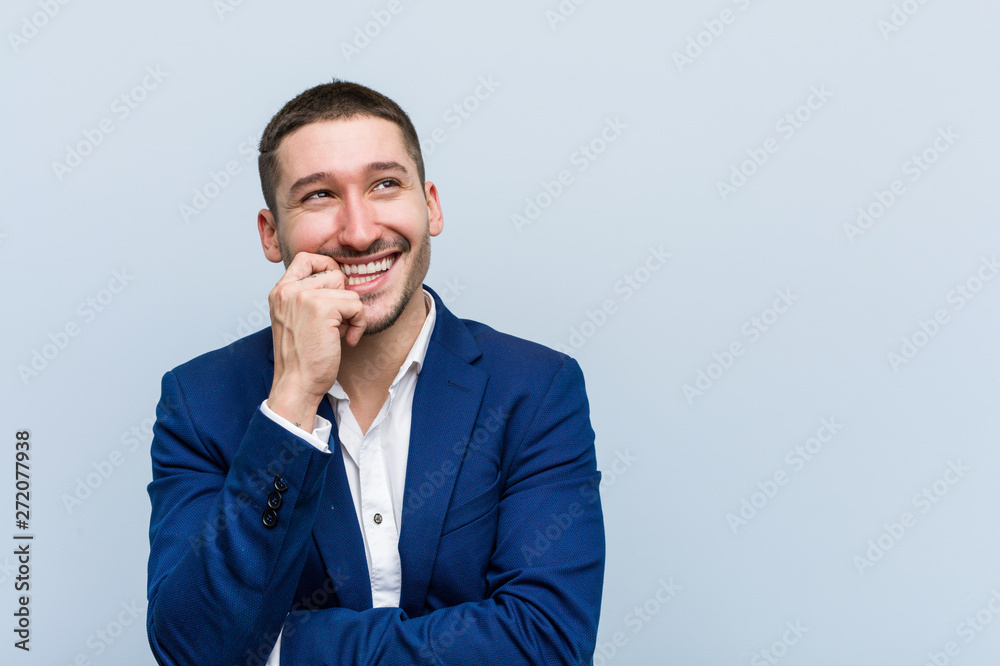 Young business caucasian man relaxed thinking about something looking at a copy space. Young business caucasian man relaxed thinking about something looking at a copy space.