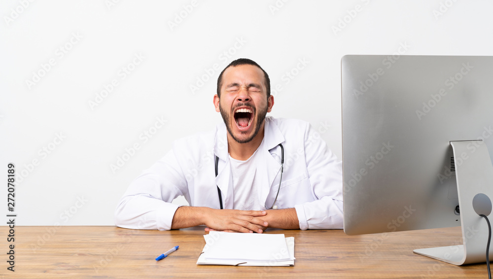 Doctor Colombian man shouting to the front with mouth wide open Doctor Colombian man shouting to the front with mouth wide open