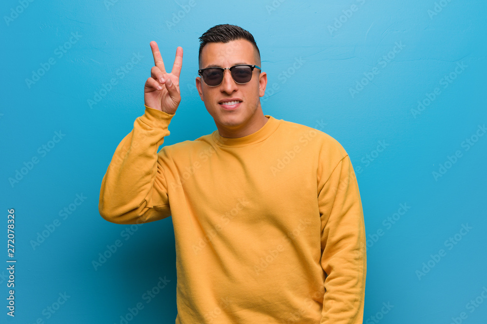 Fototapeta premium Young colombian man fun and happy doing a gesture of victory