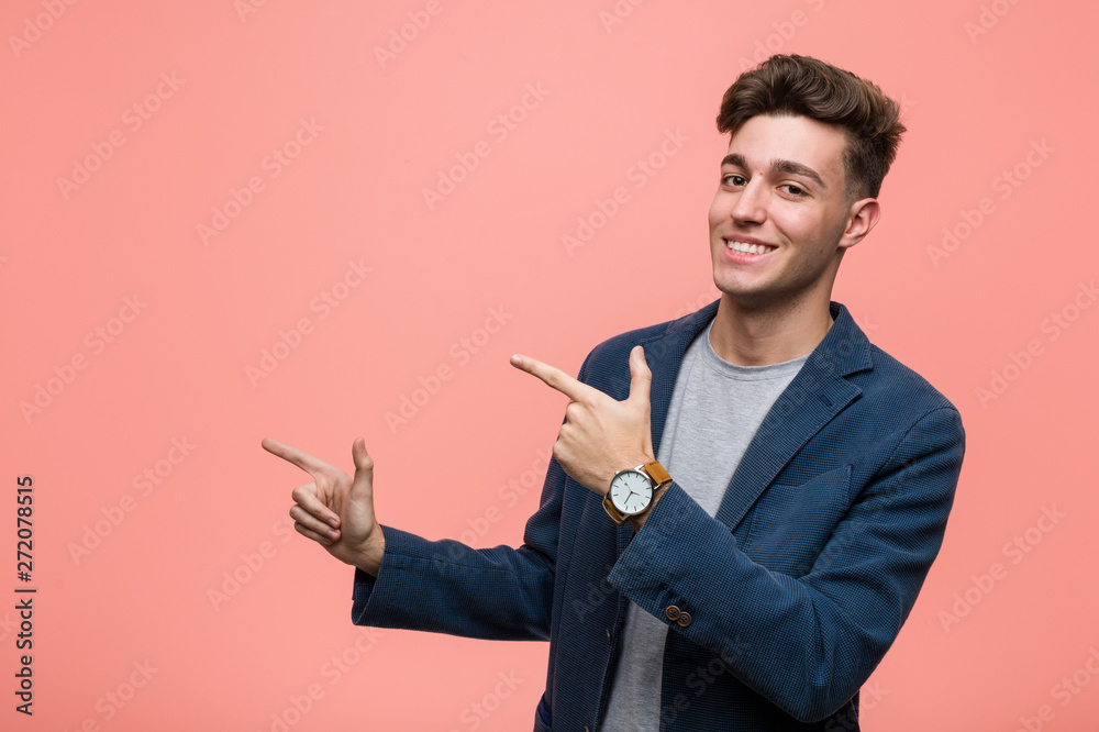 Young business natural man excited pointing with forefingers away.