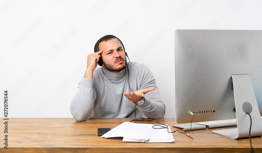 Telemarketer Colombian man making the gesture of madness putting finger on the head Telemarketer Colombian man making the gesture of madness putting finger on the head