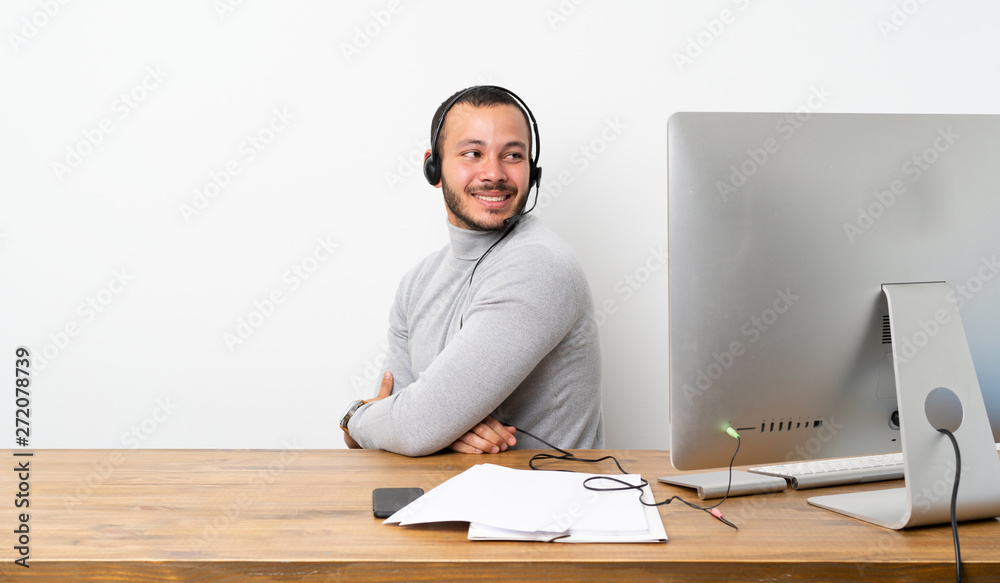 Telemarketer Colombian man with arms crossed and happy