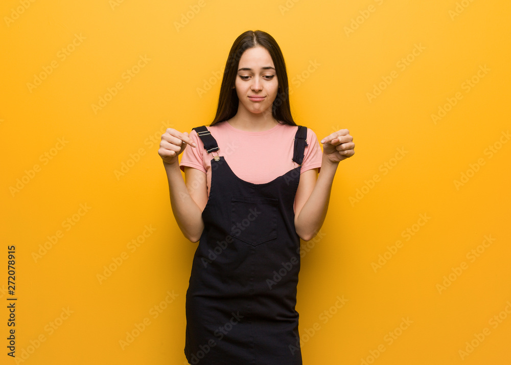 Young natural pretty girl pointing down Young natural pretty girl pointing down