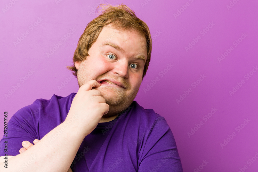 Young authentic redhead fat man biting fingernails, nervous and very anxious. Young authentic redhead fat man biting fingernails, nervous and very anxious.