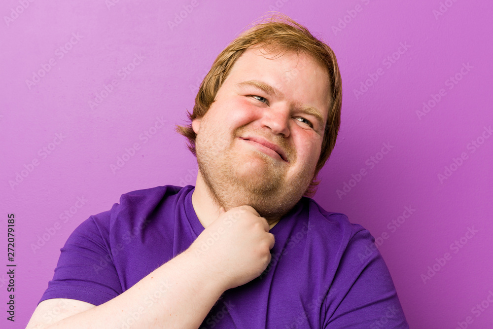 Fototapeta premium Young authentic redhead fat man suffers pain in throat due a virus or infection.