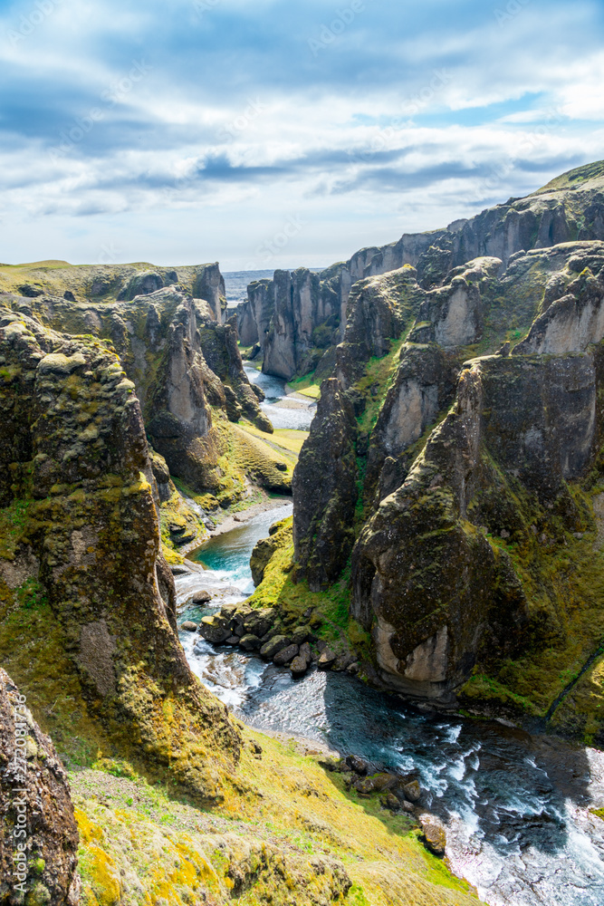 Iceland canyon fjaðrárgljúfur with river flowing through it