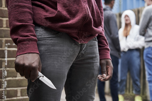 Fotografie Close Up Of  Teenage Boy In Urban Gang Holding Knife