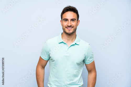 Handsome young man over isolated background laughing