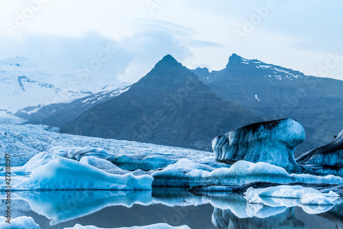 Glacier lake with icebergs with mountain and glacier in the background in Fjallsárlón, Iceland