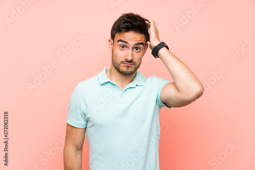 Handsome young man over isolated background with an expression of frustration and not understanding © luismolinero