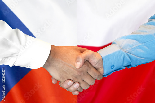 Business handshake on the background of two flags. Men handshake on the background of the Czech Republic and Poland flag. Support concept