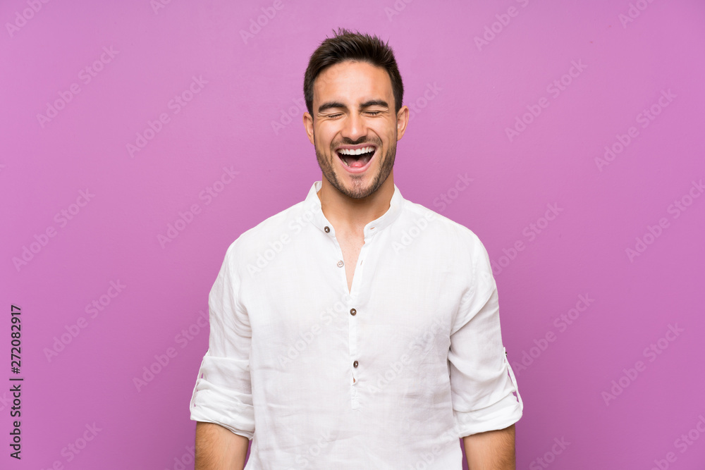 Handsome young man over isolated background shouting to the front with mouth wide open Handsome young man over isolated background shouting to the front with mouth wide open