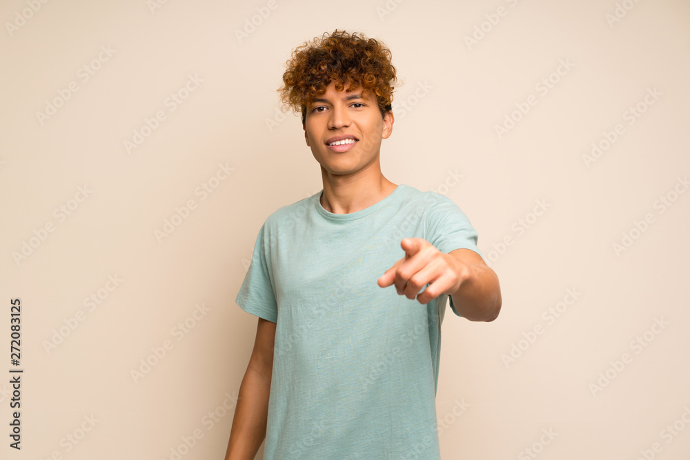 African american man with green shirt points finger at you with a confident expression African american man with green shirt points finger at you with a confident expression
