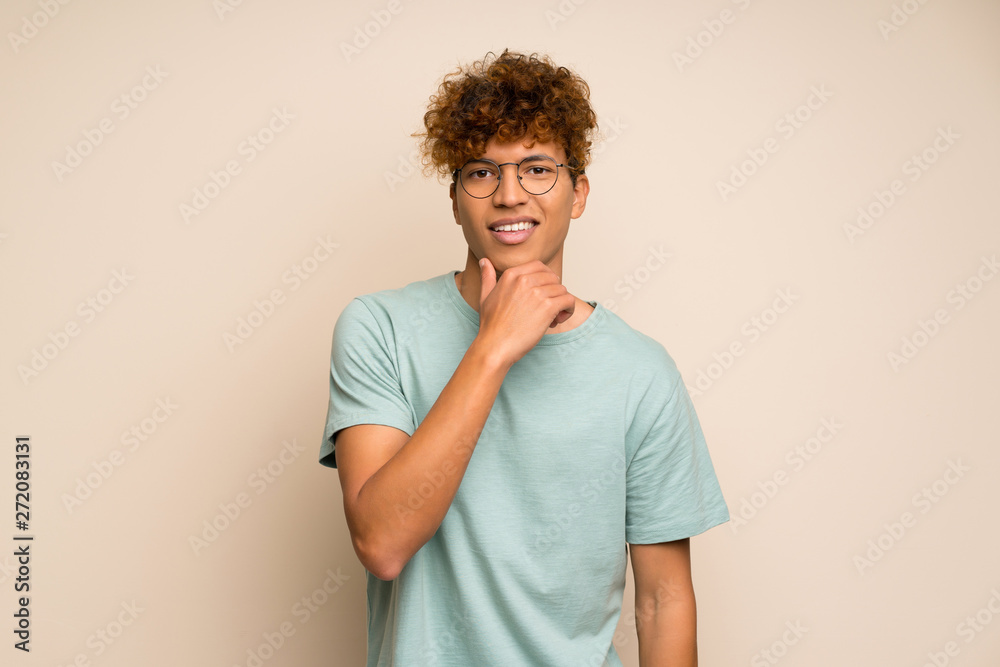 African american man with green shirt with glasses and smiling