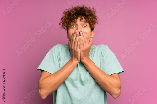 Young african american man over isolated purple wall with surprise facial expression