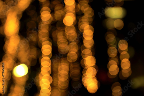 Blurry background image of defocused golden color abstract decoration lights pattern