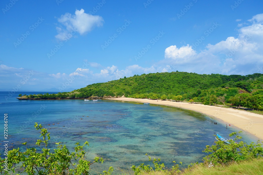 Beautiful landscape of Pantai Nipah, Lombok island scenic travel destination beach with crystal blue waters and coconut trees - near Bali, Indonesia