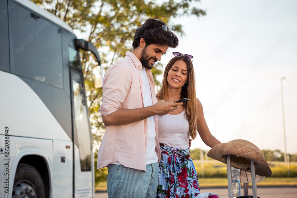 A handsome young man and his beautiful girl make online hotel reservations while waiting to board the bus. A handsome young man and his beautiful girl make online hotel reservations while waiting to board the bus.