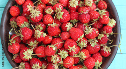 Strawberry on plate on wooden table, healthy food