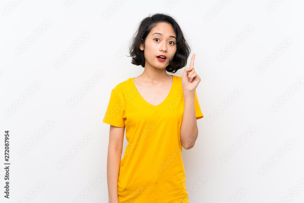 Asian young woman over isolated white background thinking an idea pointing the finger up Asian young woman over isolated white background thinking an idea pointing the finger up