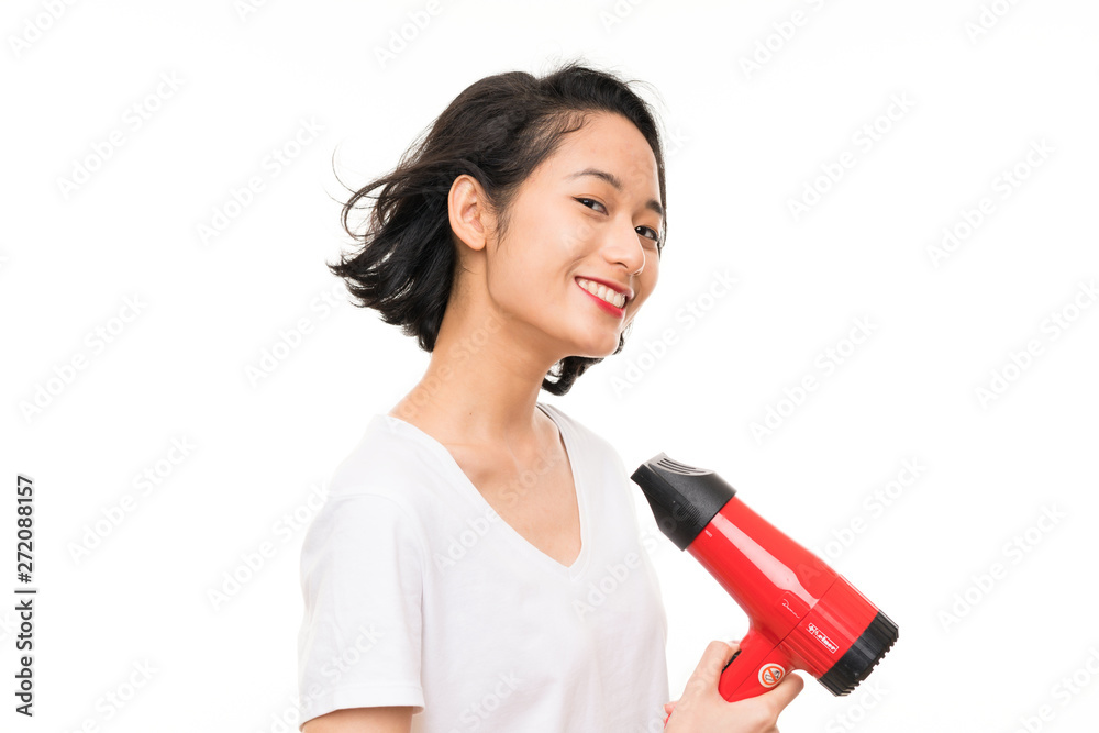 Asian young woman over isolated background with hairdryer Asian young woman over isolated background with hairdryer